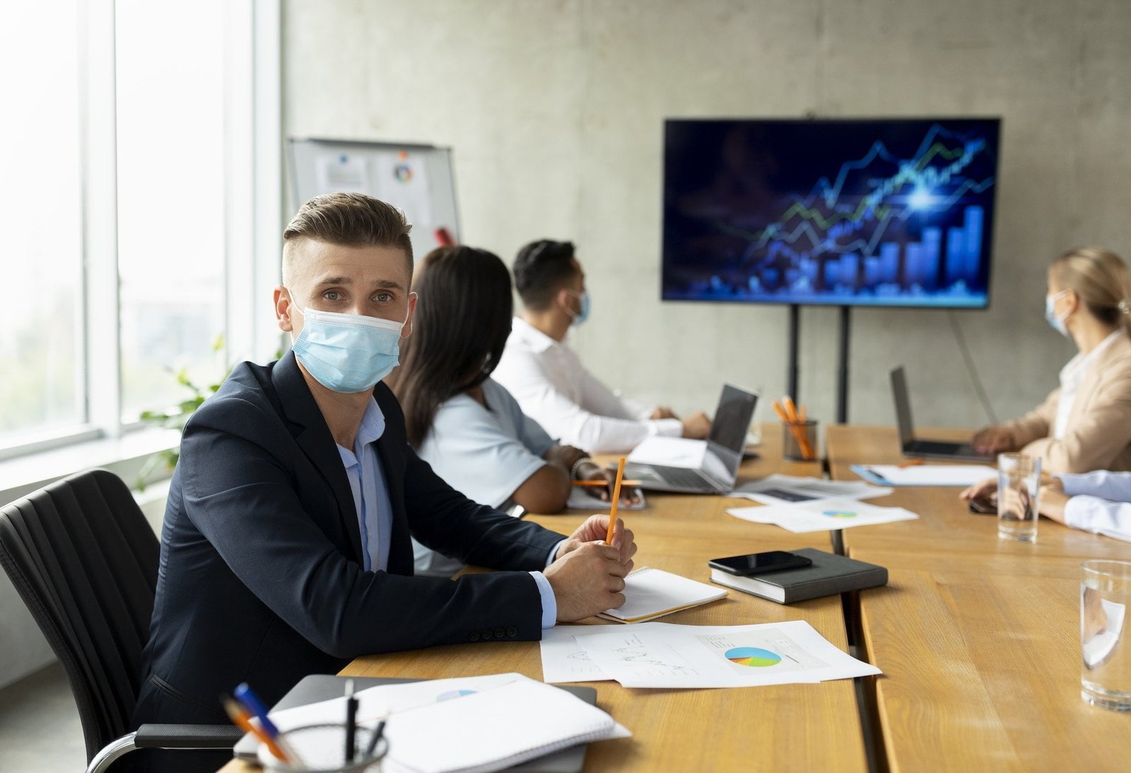 Workplace Healthcare. Multiethnic Business Team Wearing Medical Masks Having Meeting In Office